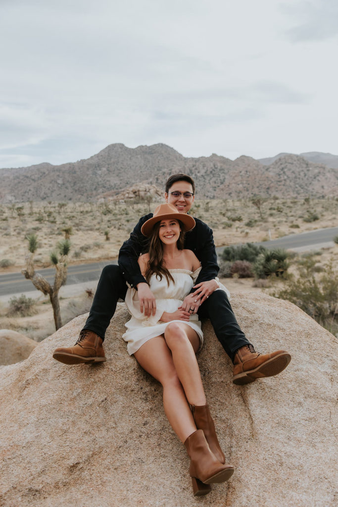 Engagement photos taken in Joshua Tree California sitting on some rocks