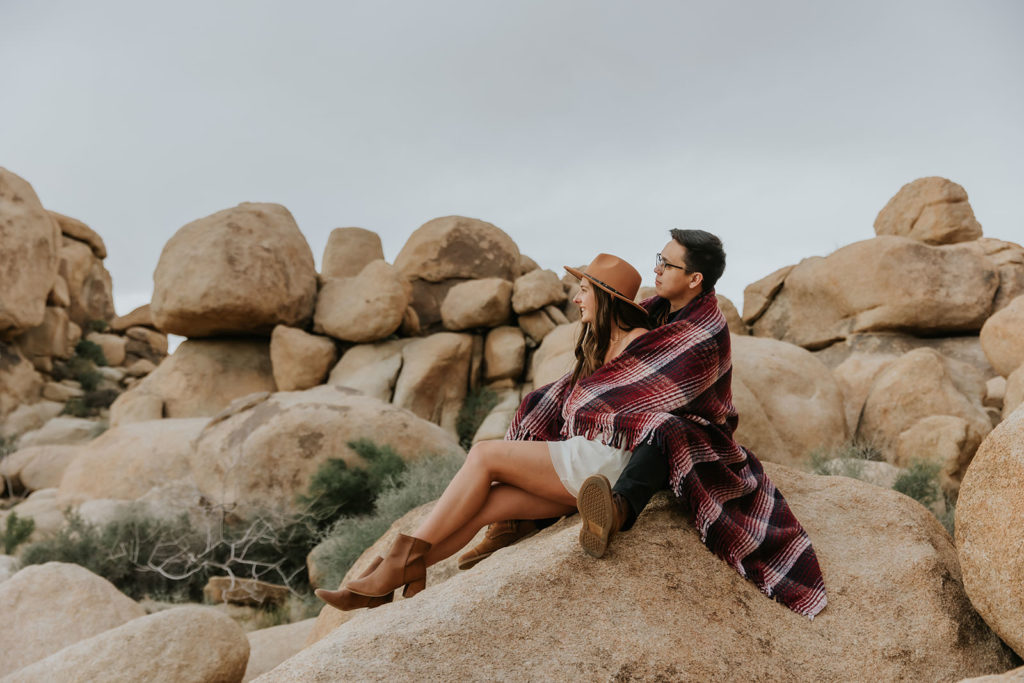Engagement photos taken in Joshua Tree California sitting on some rocks