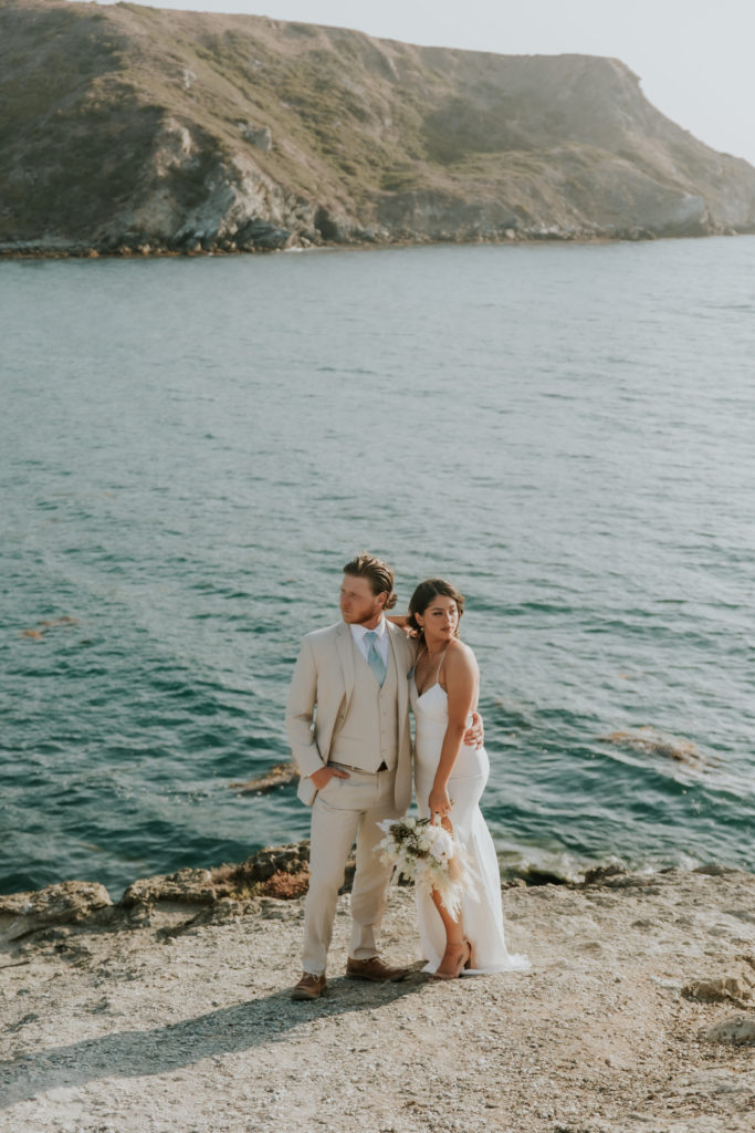 Bride and Groom standing on a cliff edge on Catalina Island