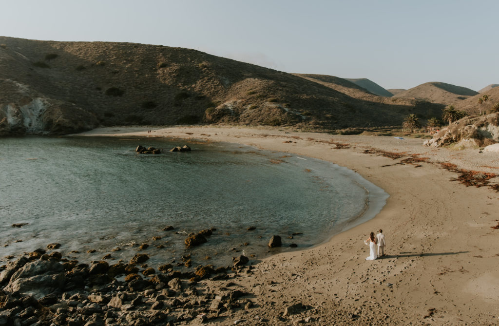 Landscape Photo of Bride and Groom walking on the beach on Catalina Island