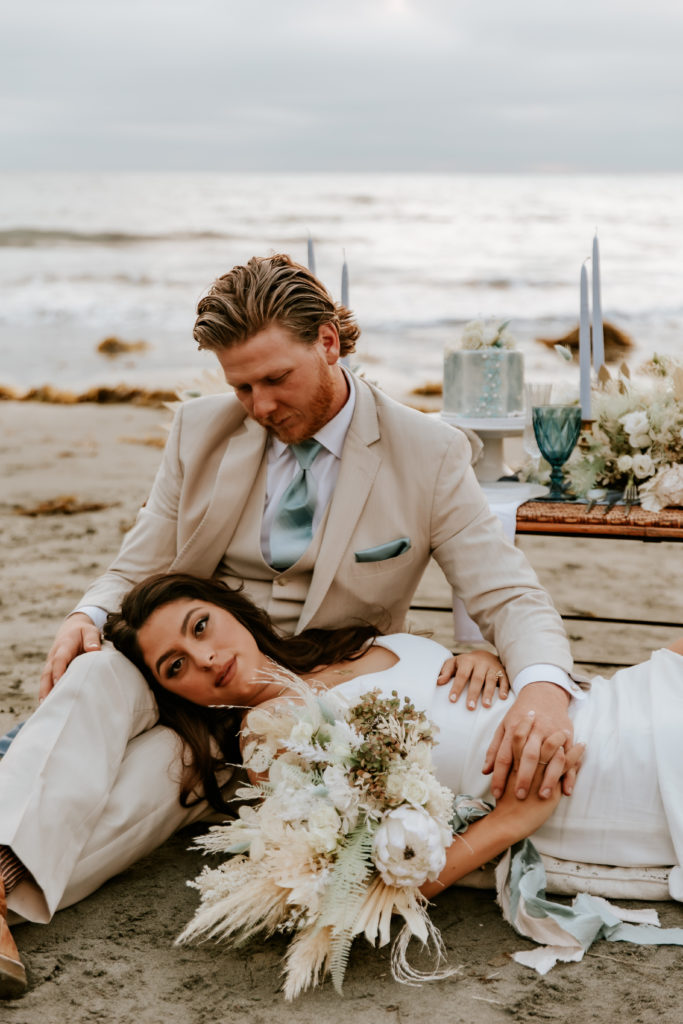 Bride Laying on Grooms Lap on Catalina Island Beach