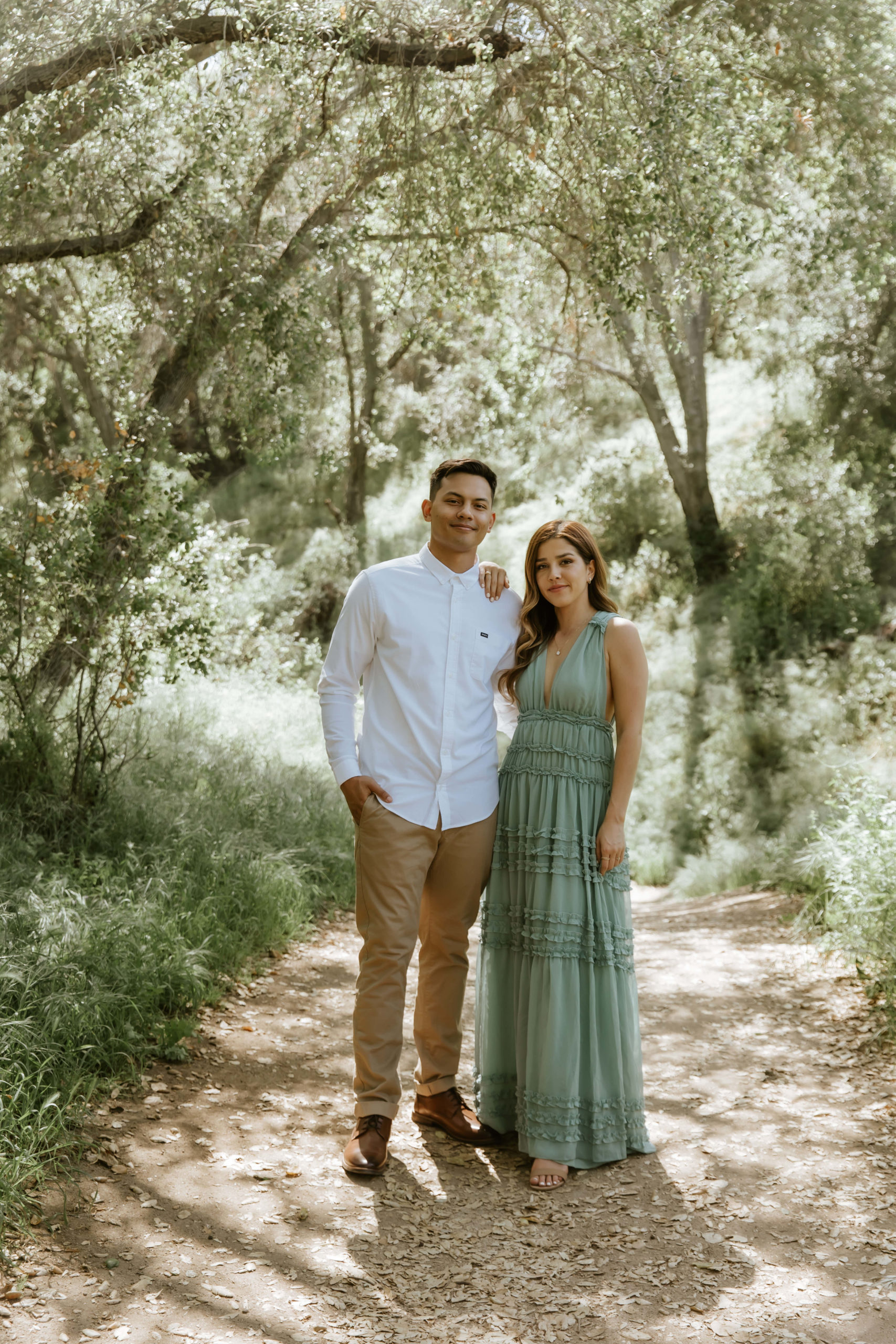 cute casual photo of couple standing in the forest during their engagement photos