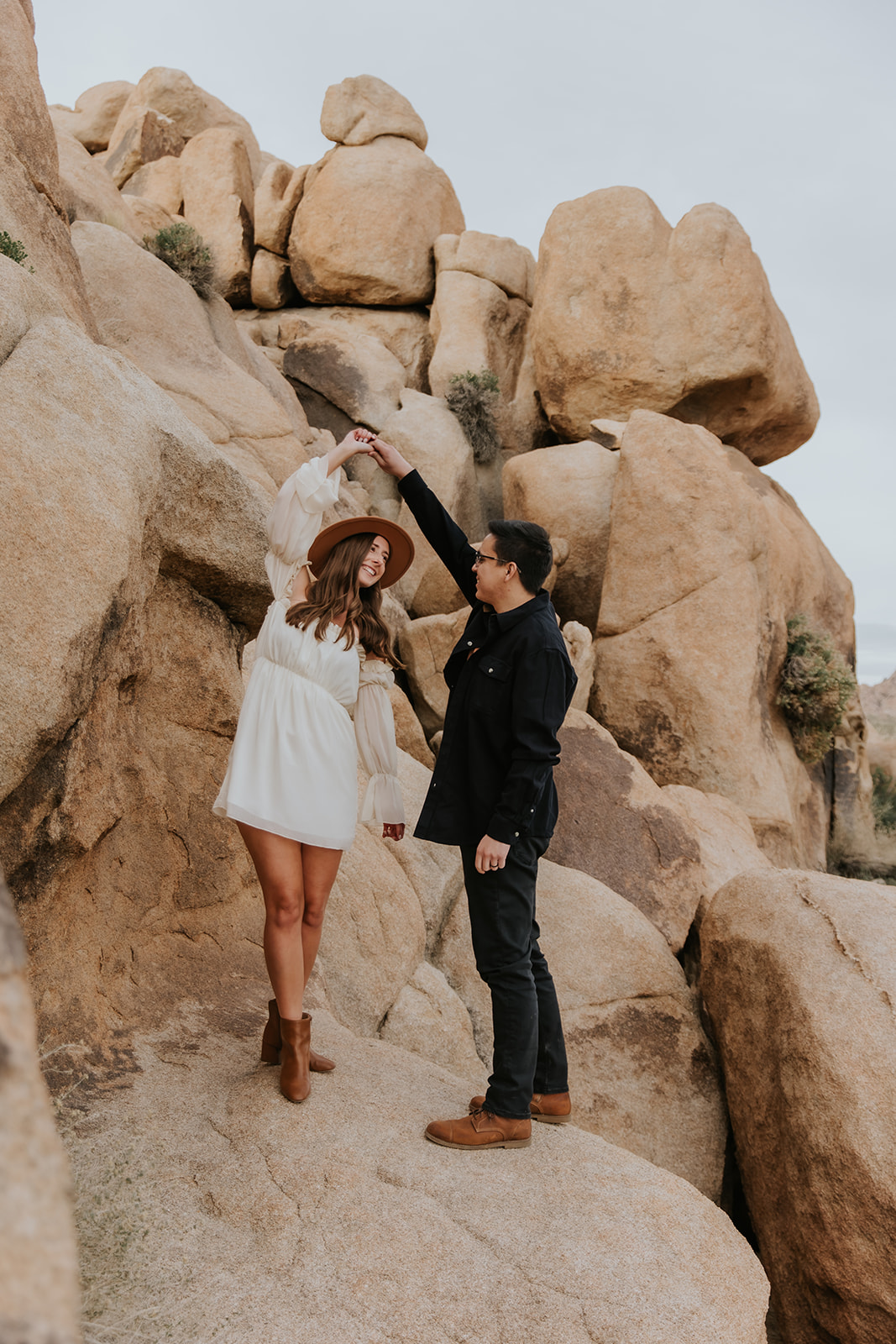 fiance twirling his fiancee during their joshua tree engagement session