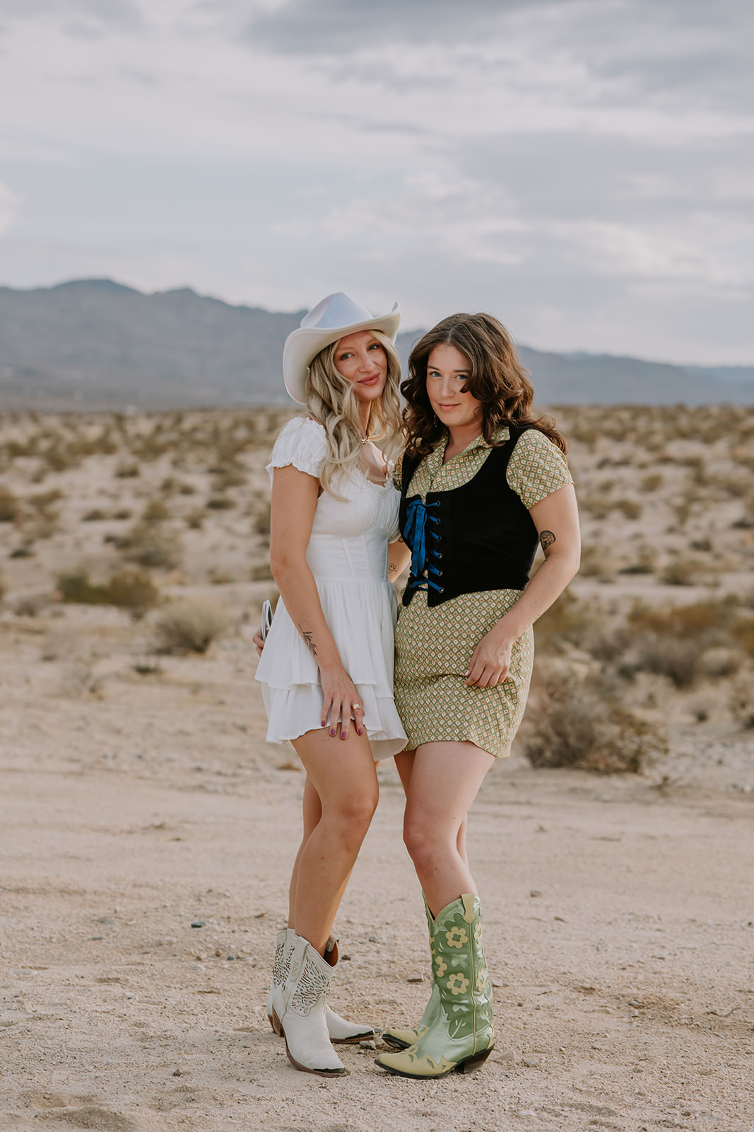Bride with one of her bridesmaids posing in the desert at her bachelorette party