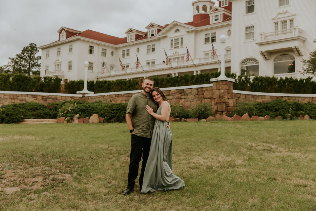 couple posed outside of the stanley hotel in estes park colorado