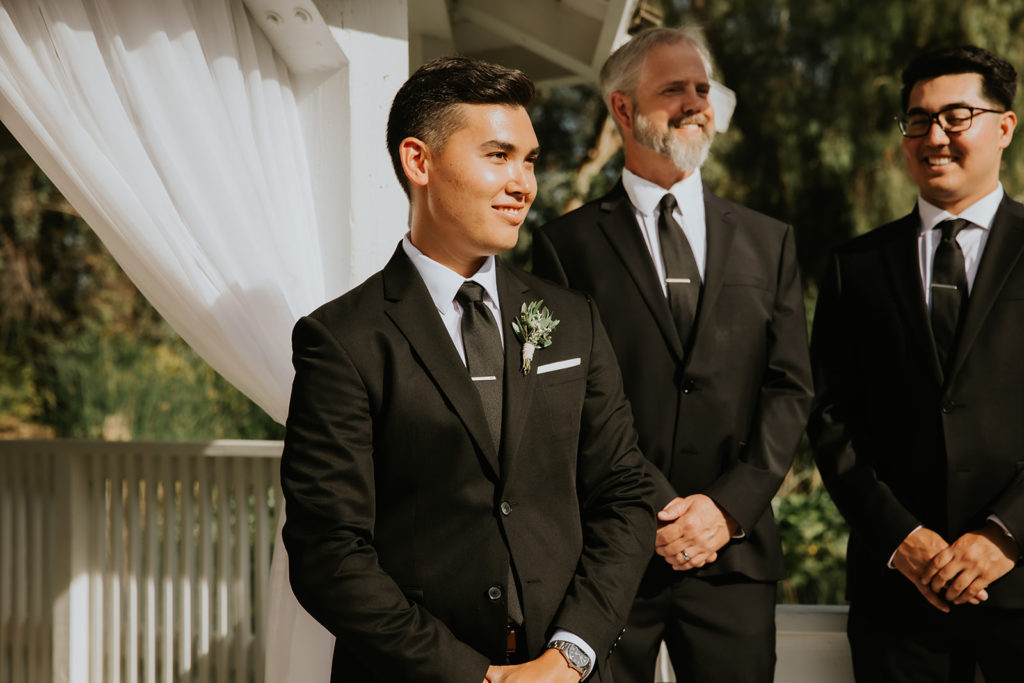 Groom Standing at the Alter at the Orchard by Wedgewood weddings in Menifee California