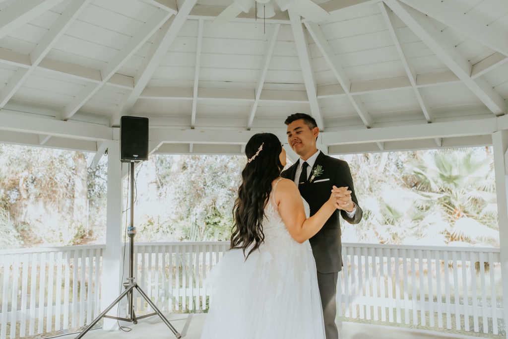bride and grooms first dance under the gazebo at the orchard