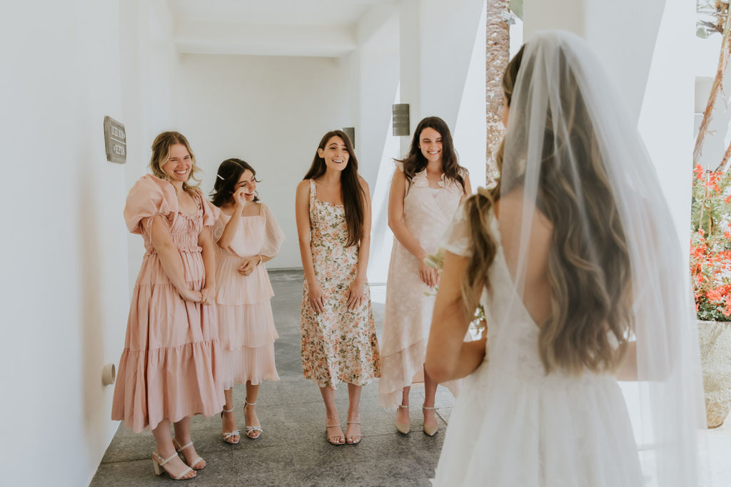 Bride having first look with her bridesmaids