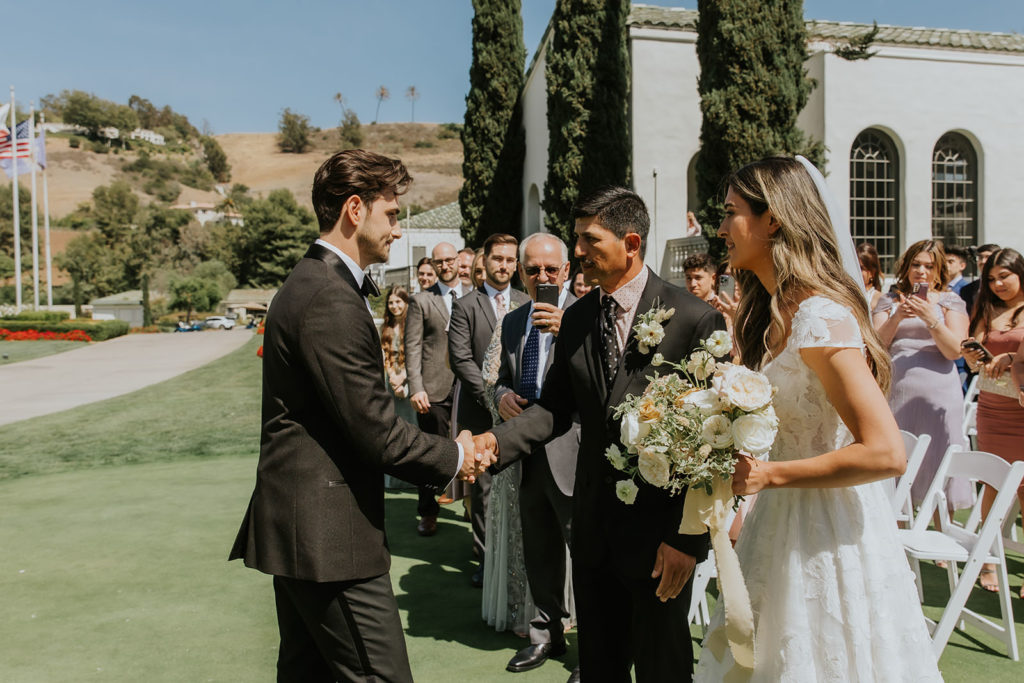Groom shaking the hand of the brides father at the Marbella Country Club in San Juan Capistrano