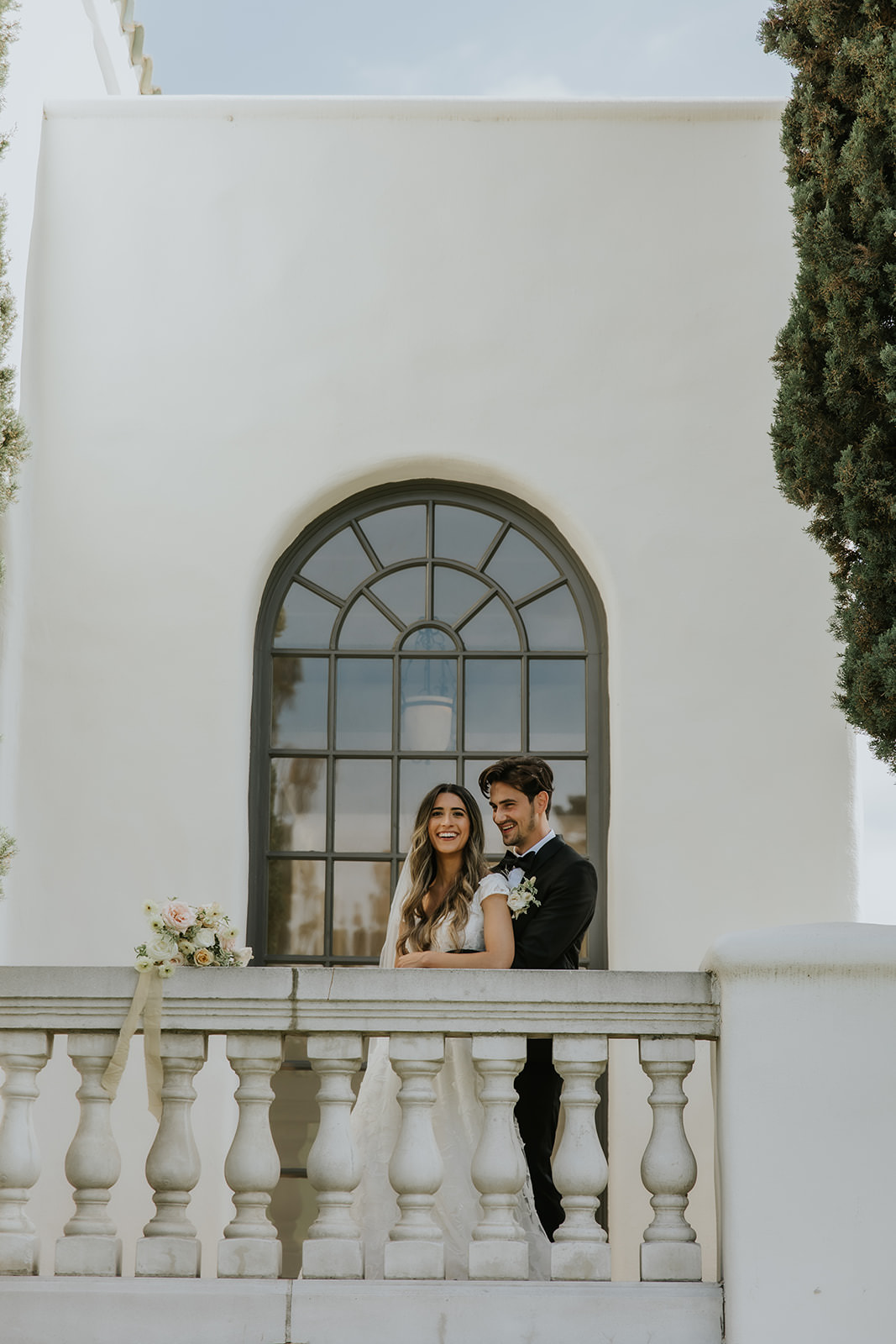 Bride and Groom Portrait on the balcony of the reception space at marbella country club in san juan capistrano