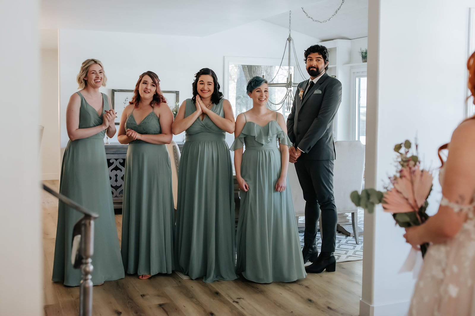 bridal party crying a clapping after seeing the bride for the first time dressed in her wedding attire