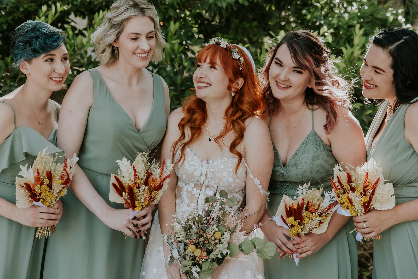 bride and bridesmaids smiling at each other