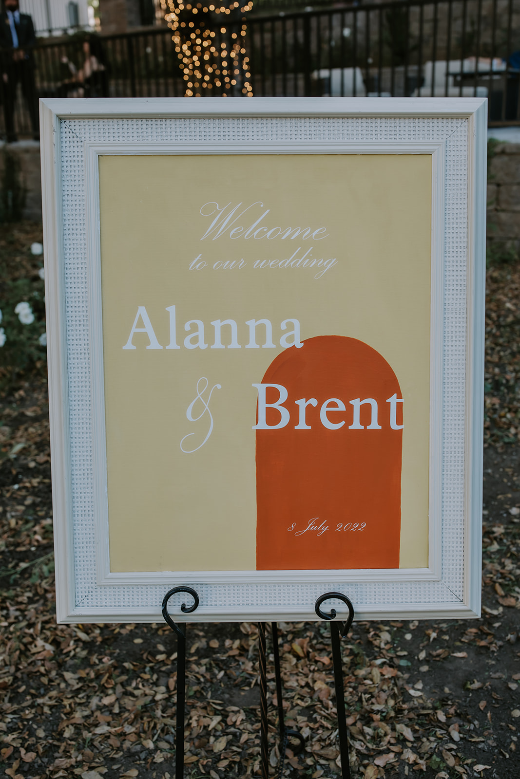 sign with the bride and grooms names at the entrance of the ceremony