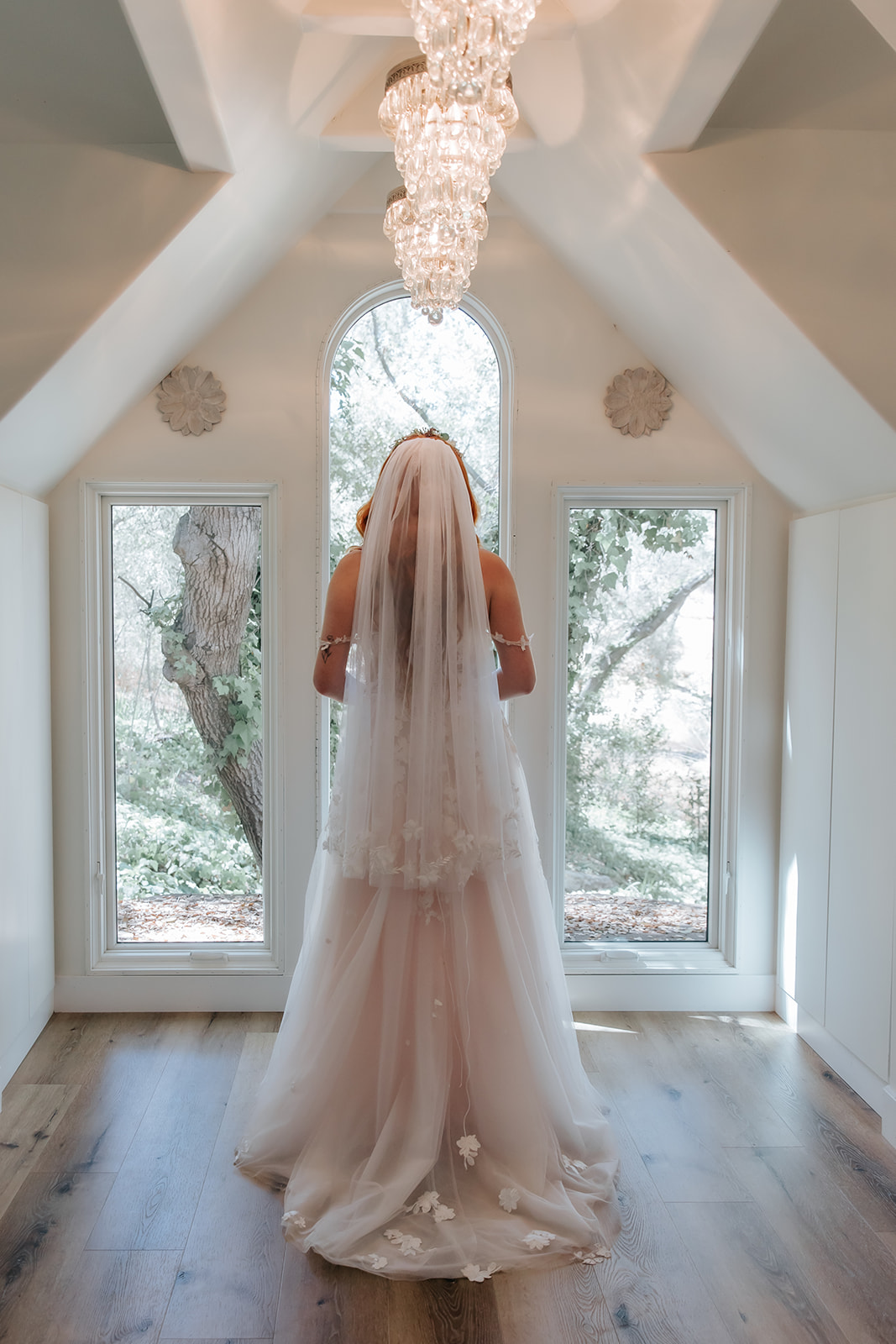 bride pictured facing away from the camera in her dress and veil