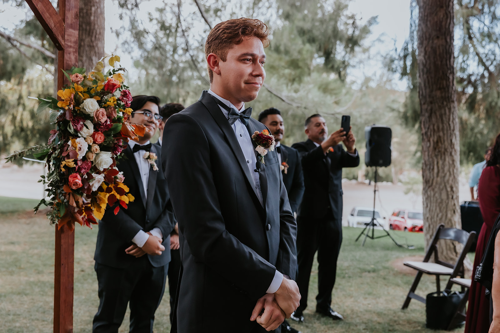 groom smiling at bride as she walks down the aisle towards him during their ceremony at Blomgren Ranch
