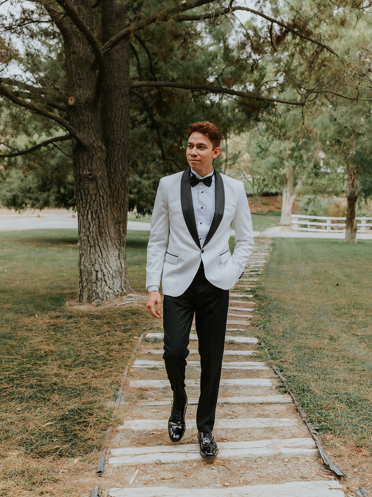 Groom walking down a path at the Blomgren Ranch