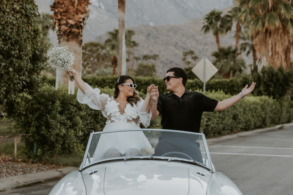 newly engaged couple sitting in a classic car in Indian Canyon 